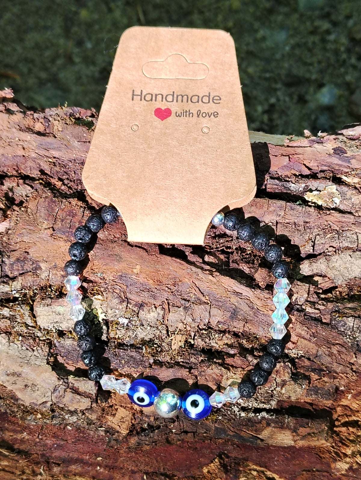 Eyes of Protection bracelet on log display