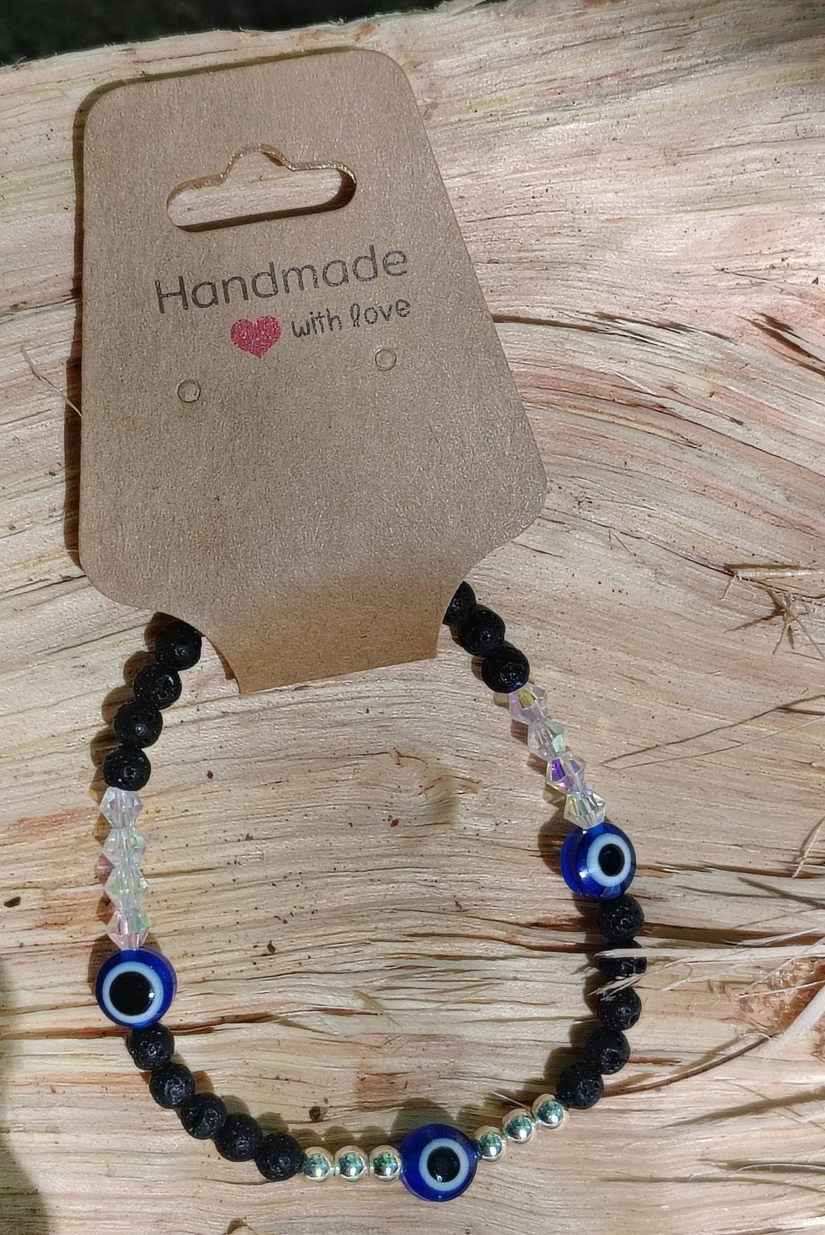 Eyes of Strength bracelet on wooden display card